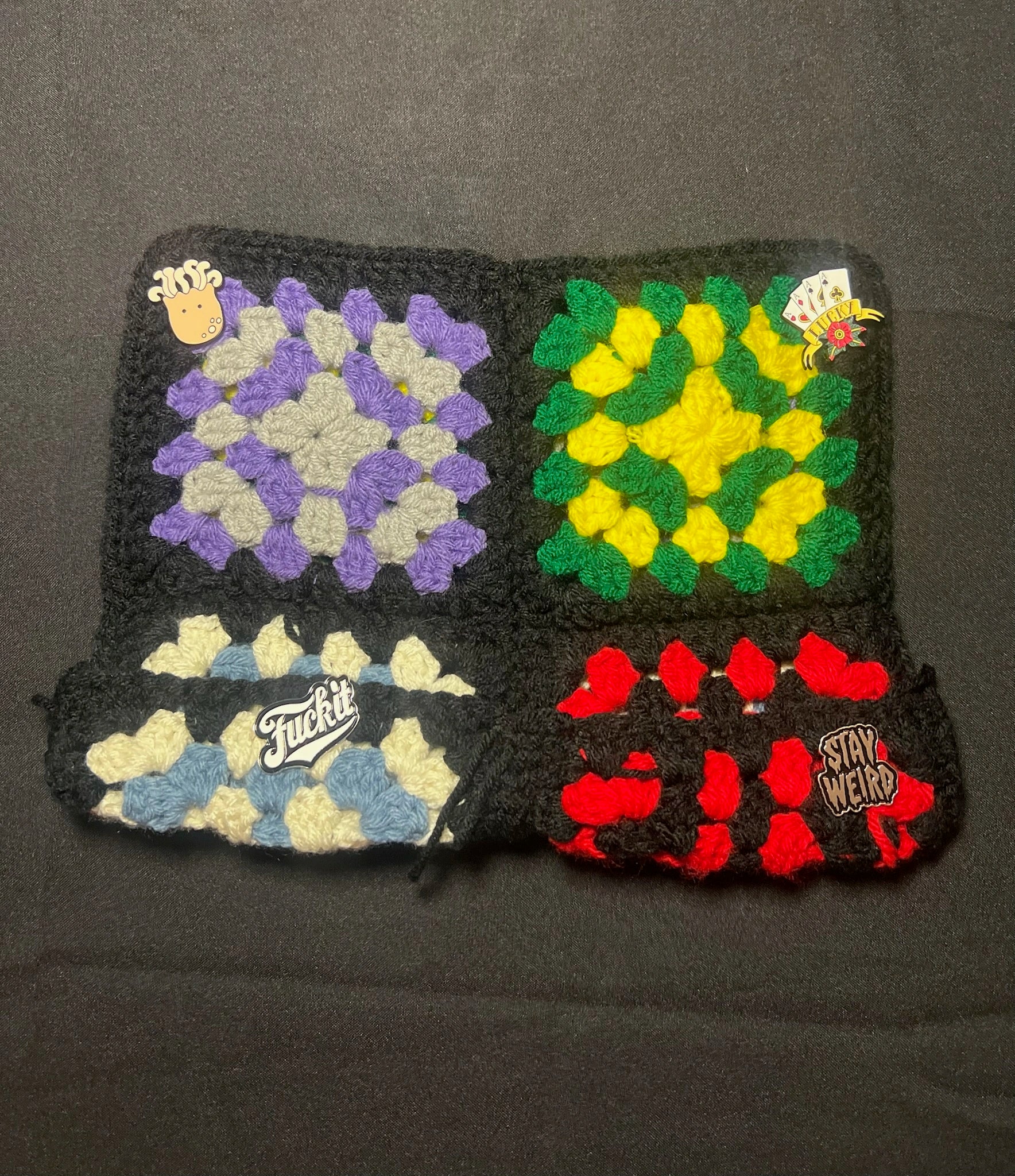 Four colorful crochet patches hat on a dark background